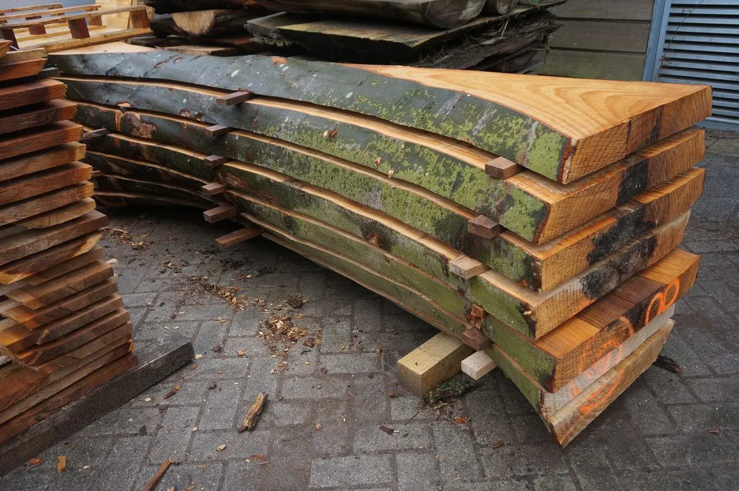 Stacked sawn trunk slabs at the Stadshout sawmill in Amsterdam